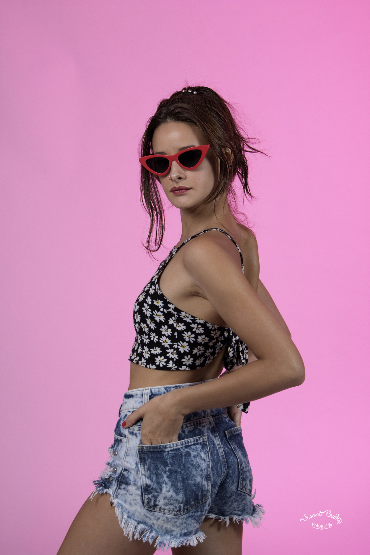 Chica con top. short de jean y lentes. short de jean y lentes, mirando hacia atras