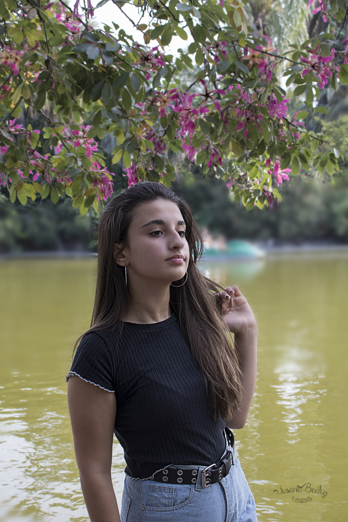 retrato quinceañera con remera negra agarrándose el pelo