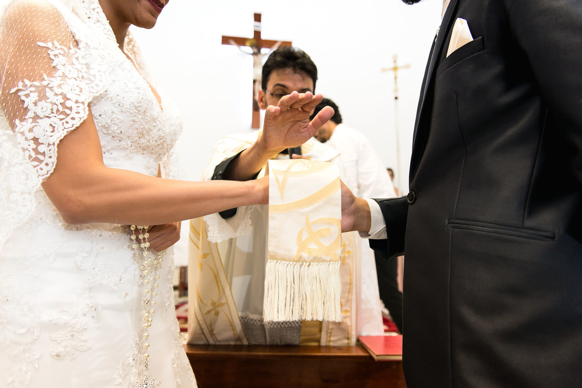 padre abençoa casal durante a cerimonia do casamento laudiceia e clayton