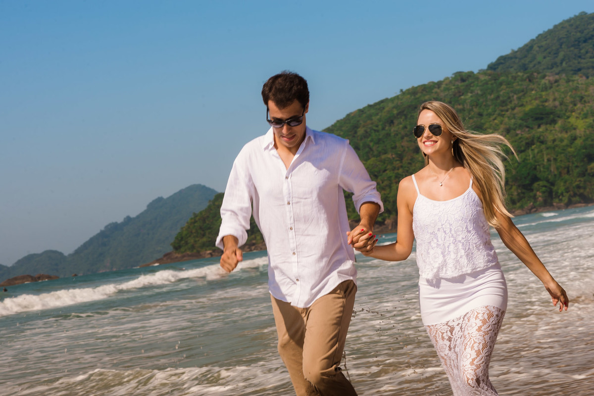 casal caminhando em direção ao mar