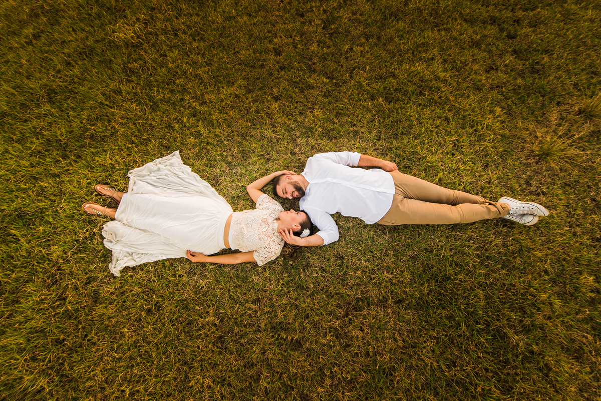 ensaio de casal, pre-wedding casal deitado em campo de feno no por do sol em Holambra cidade das flores