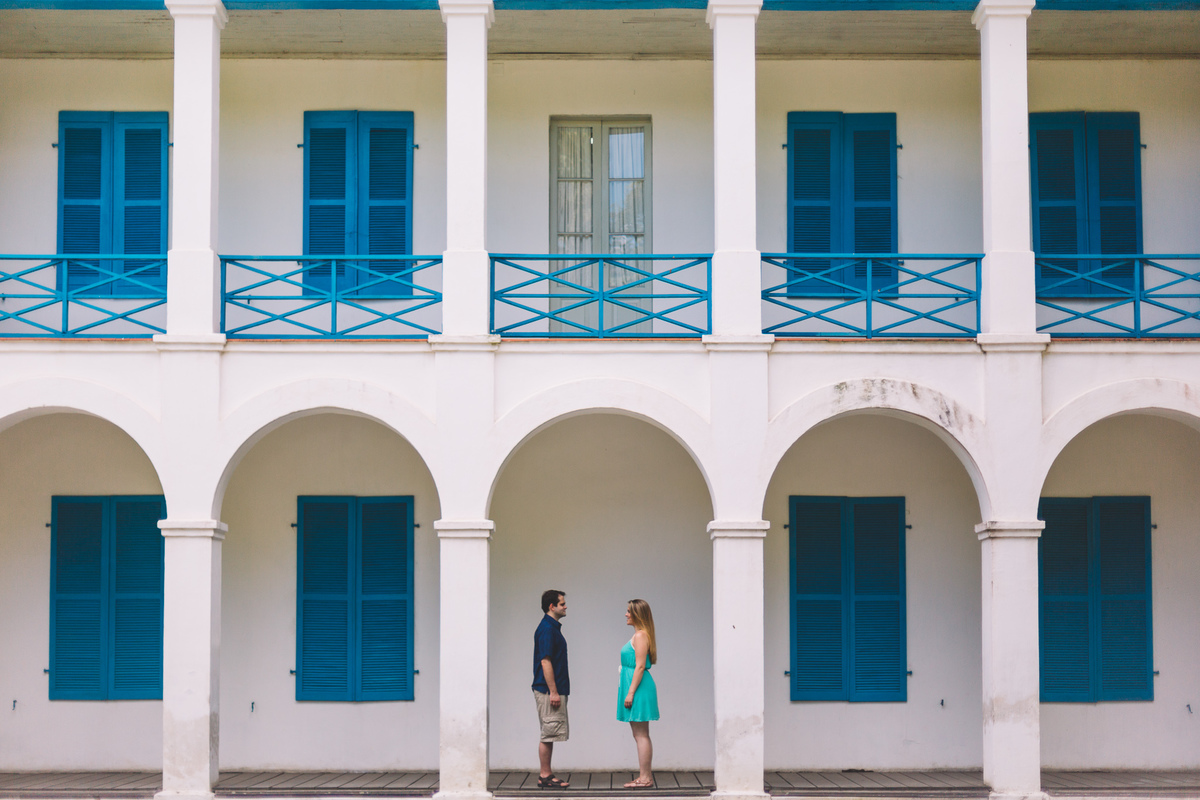 Casal um de frente para o outro entre os pilares do prédio histórico