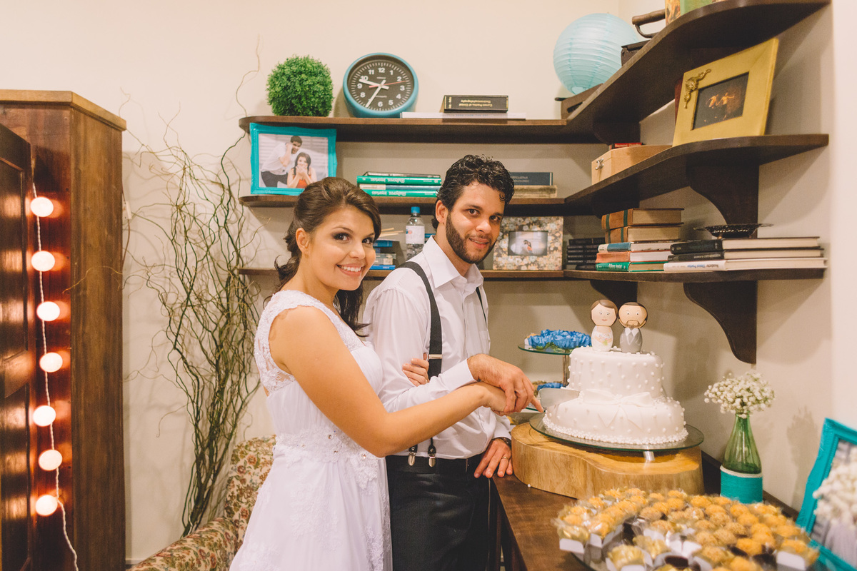 Foto posada com o casal cortando o bolo de casamento