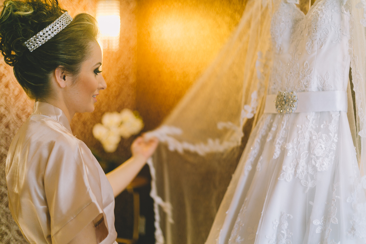 Noiva encostando e sentindo o tecido do vestido