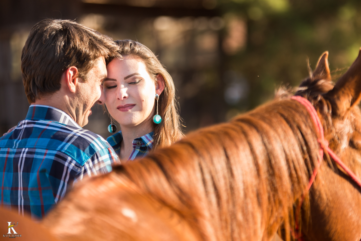 sessão pre casamento, na fazenda com cavalos e outros animais, com um casal com roupas cowntry a noiva com vestido branco, registrado pela fotografa katy tesser