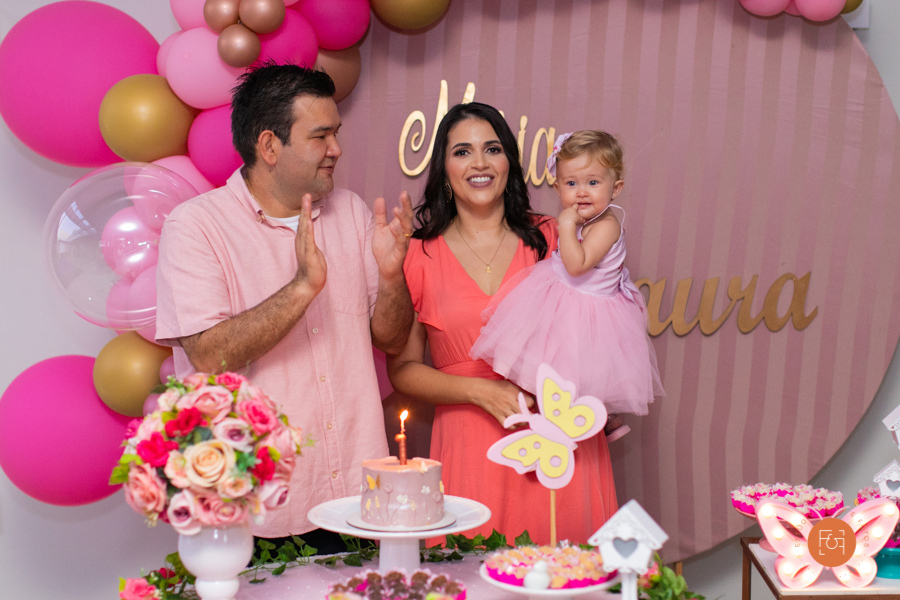 aniversariante menina cantando parabéns com os pais