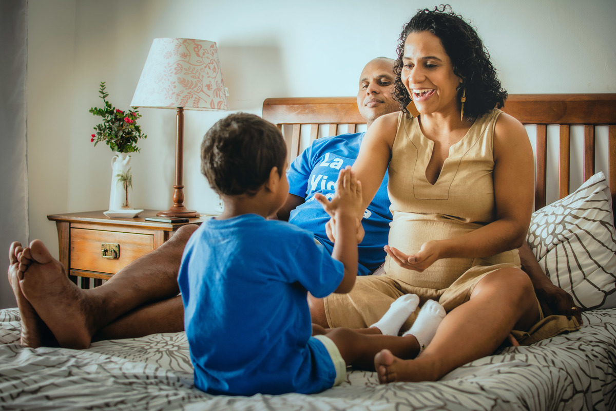 Mãe e filho brincando de pedra, papel e tesoura.