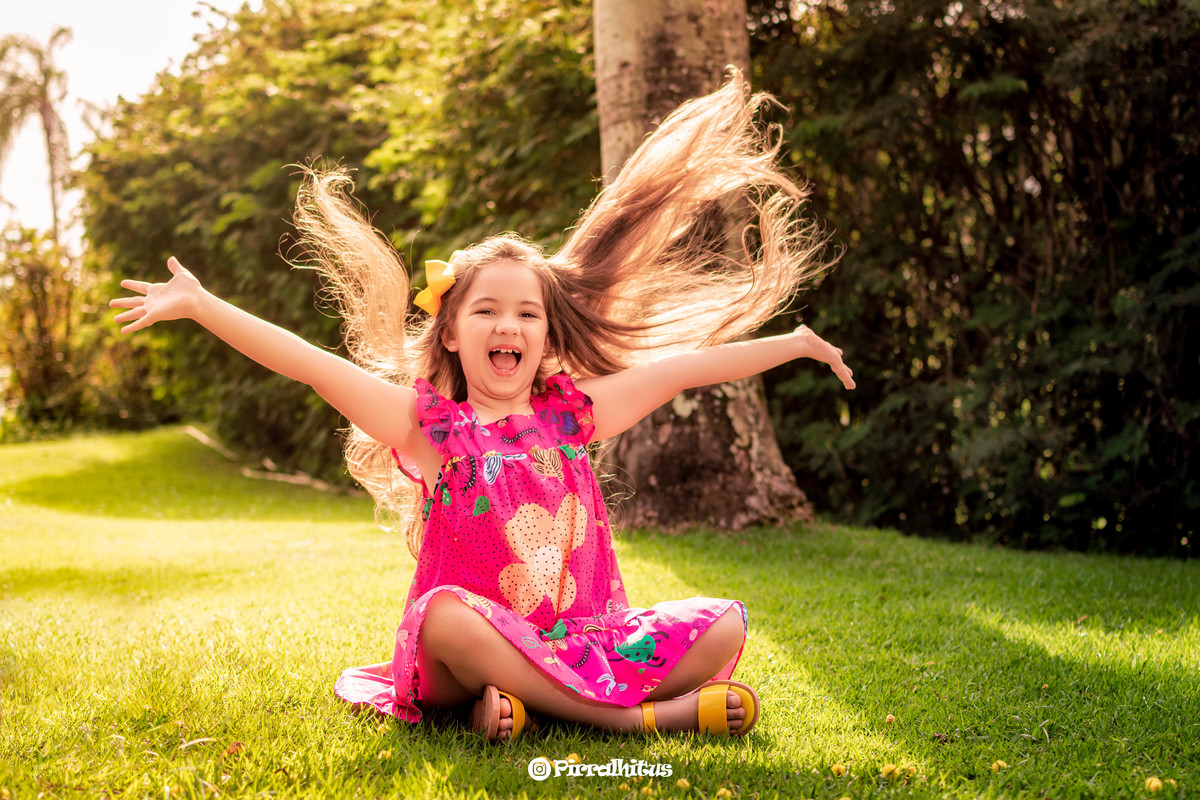 Menina loira com cabelos esvoaçantes em ensaio fotográfico no Rio 2 Park.
