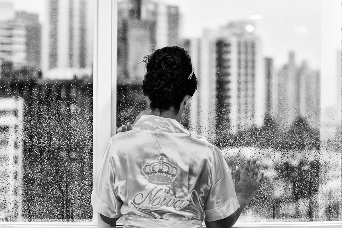 noiva olhando na janela do hotel