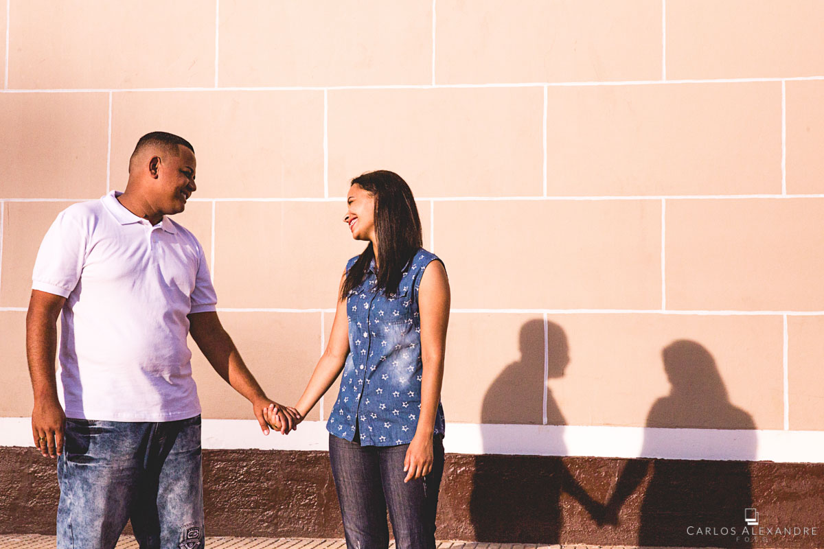 luz e sombra moldam o casal de mãos dadas fotografado pelo fotógrafo carlos alexandre foto de três corações sul de minas
