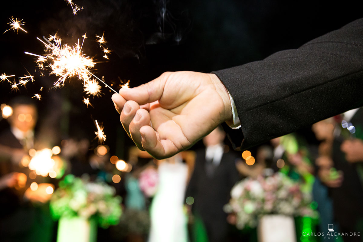 homem segurando estalinho na saída dos noivos felizes para sempre