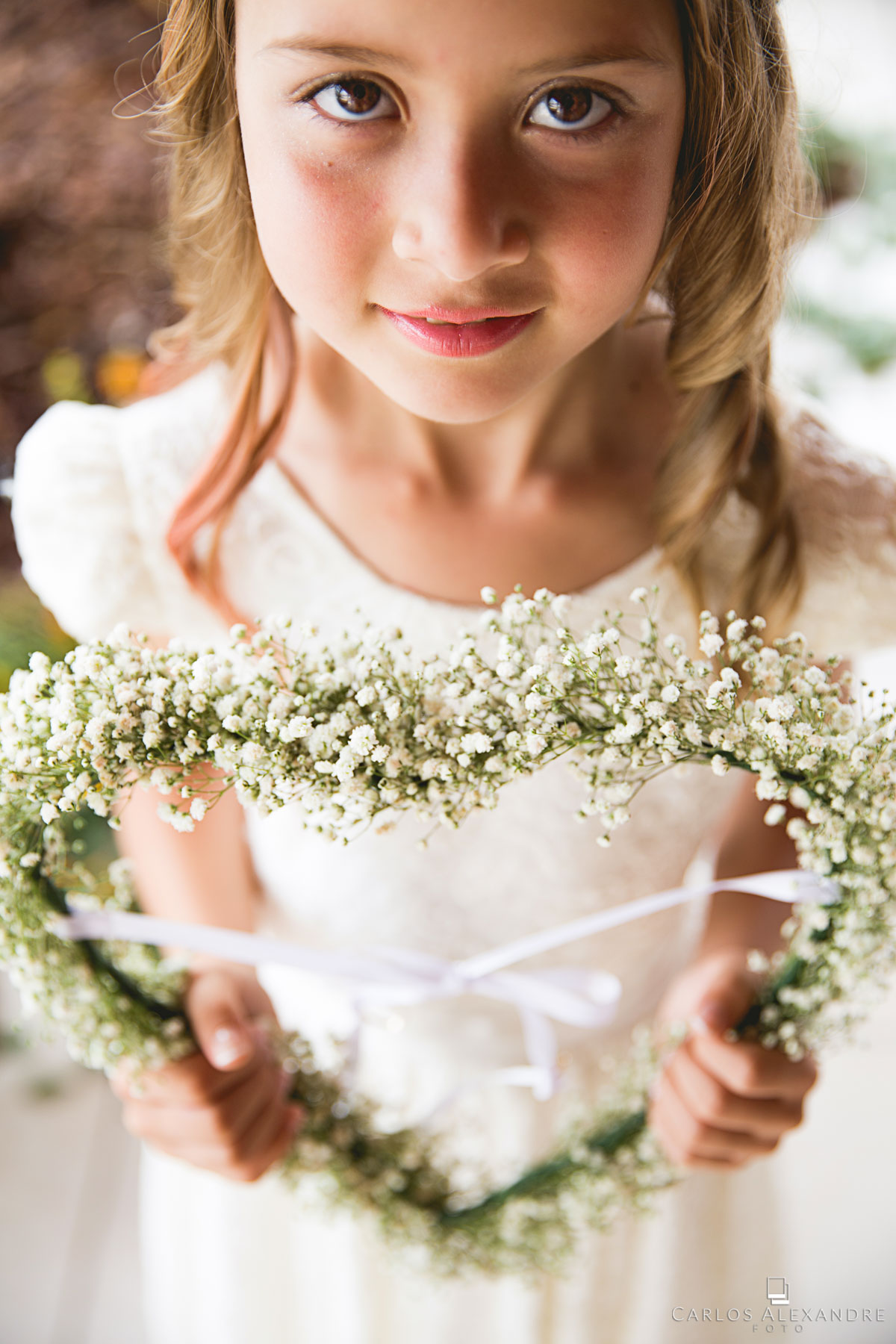 filha dos noivos se preparando para entrar com as alianças