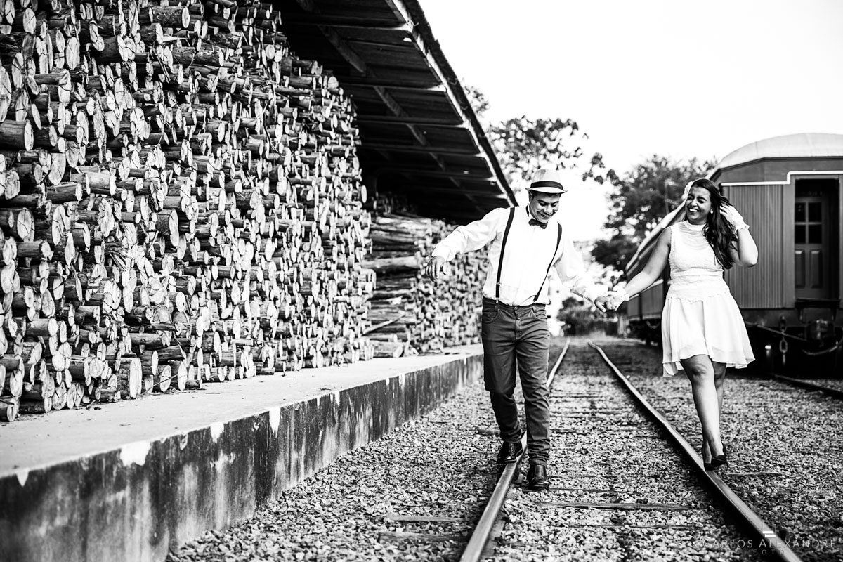 enamorados brincando e andando em cima dos trilhos