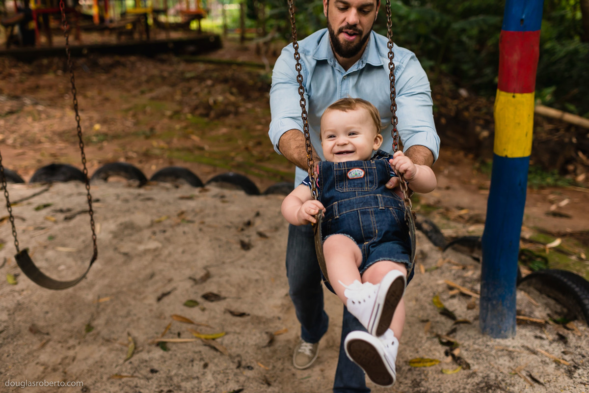 pai empurrando o filho no balanço