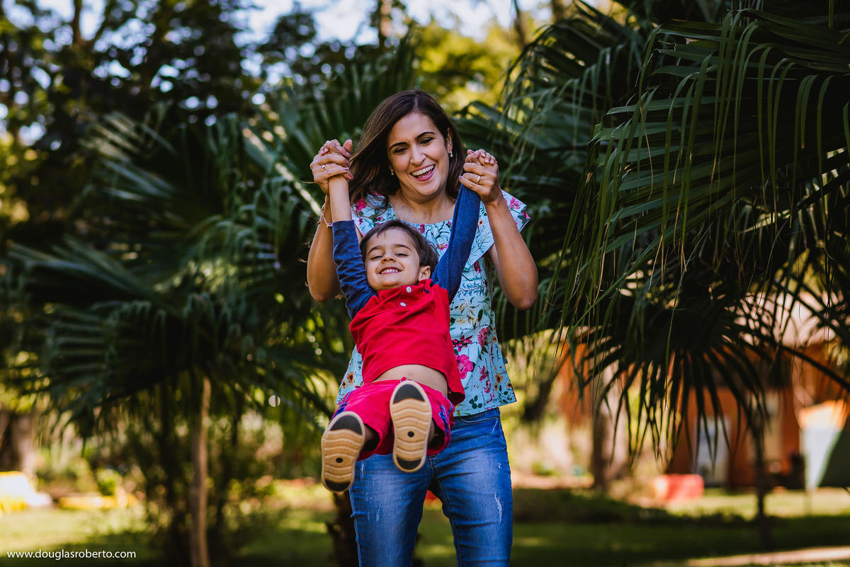 mãe brincando de jogar o filho para cima
