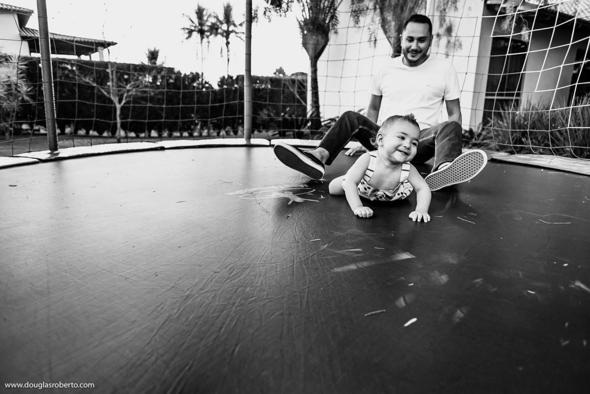 pai brincando com a filha no pula pula
