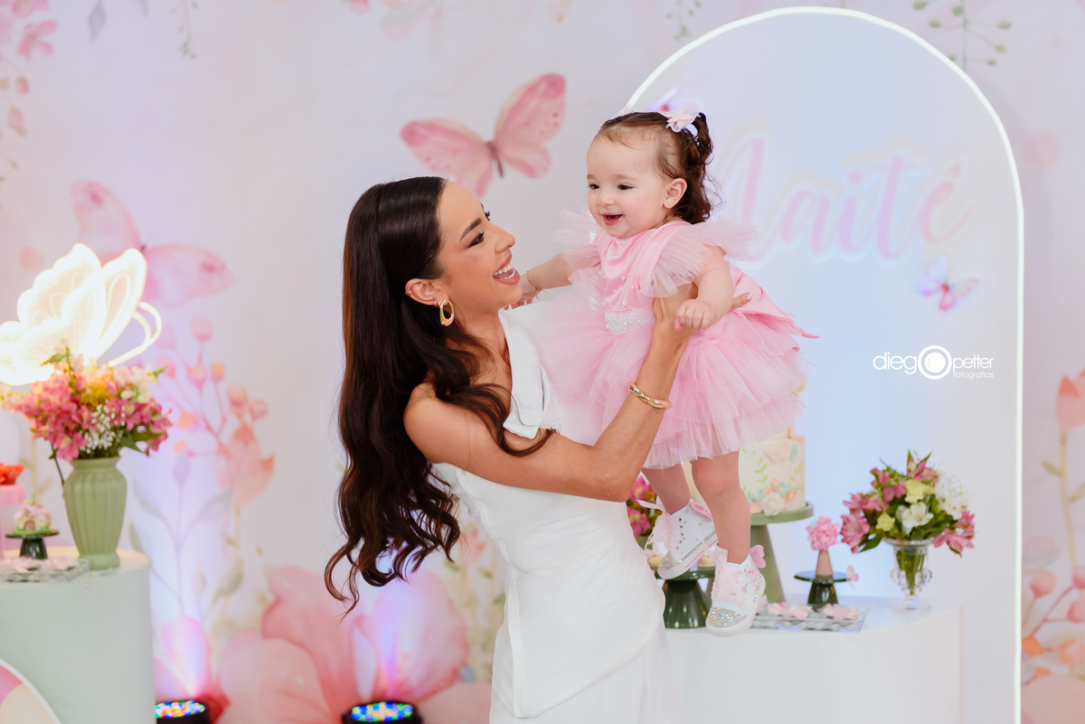 mãe brincando de aviãozinho com a filha