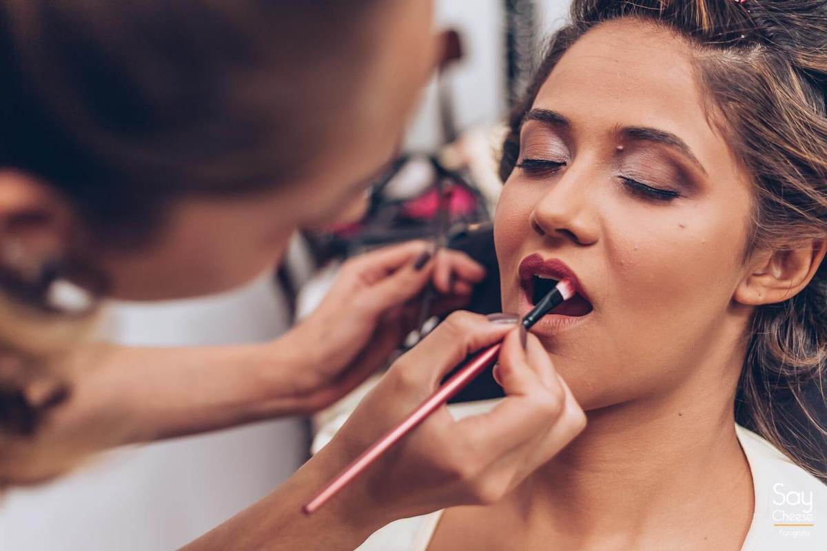 maquiadora passando batom na noiva durante Making Of da noiva fotografado por Say Cheese Fotografia