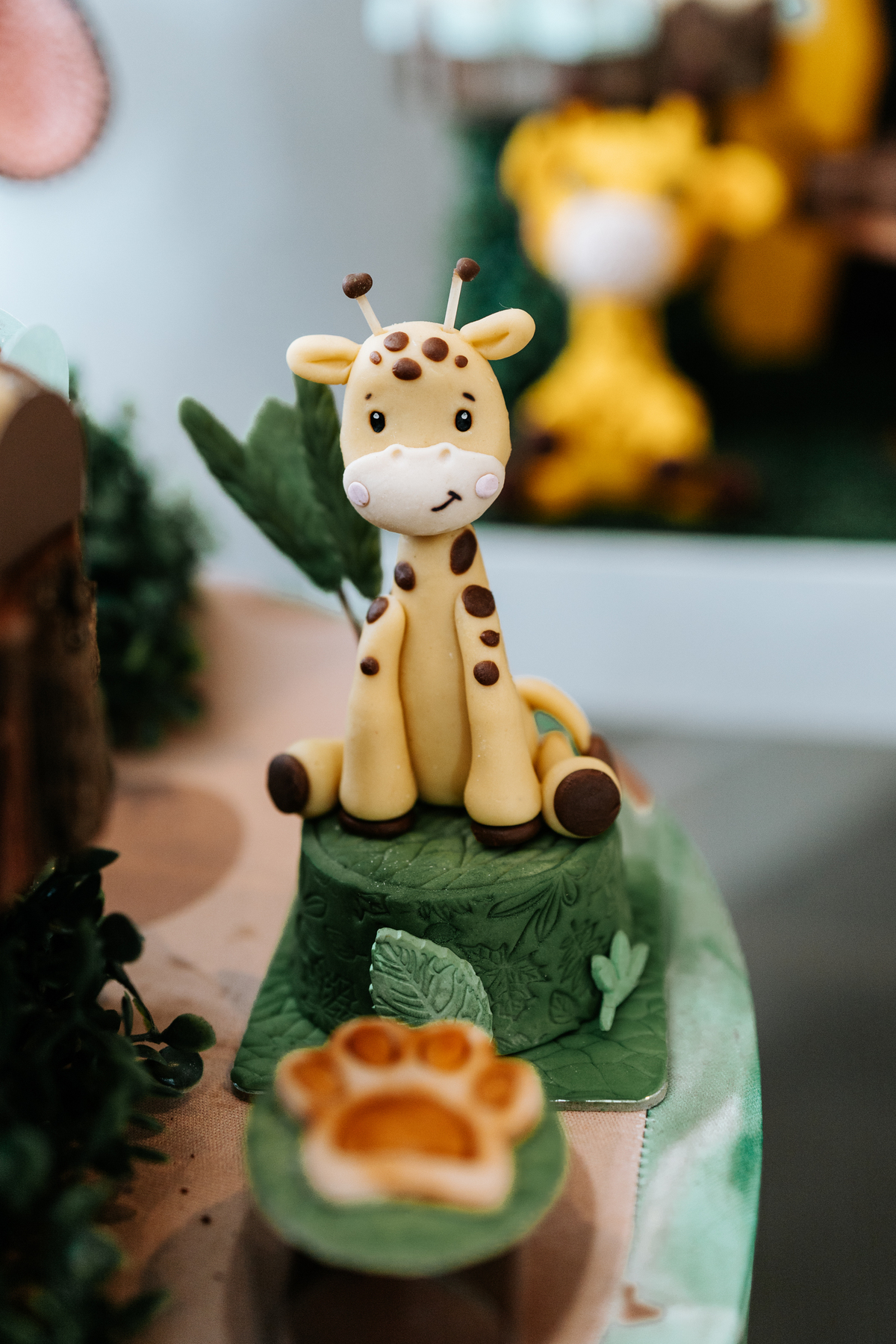 Foto em macro de um enfeite de girafa esculpido em açúcar no topo do doce.