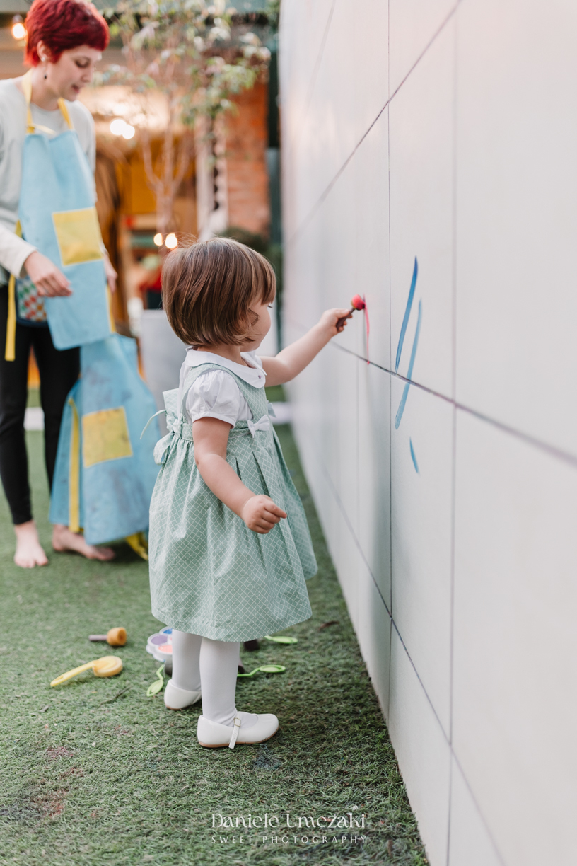Fotografia de aniversário infantil em São Paulo. Festa intimista de 2 anos da Manuela no Quintal Decorinha, com bolinhas de sabão, pintura e caixa de areia. Registro leve e afetivo por Dani Umezaki