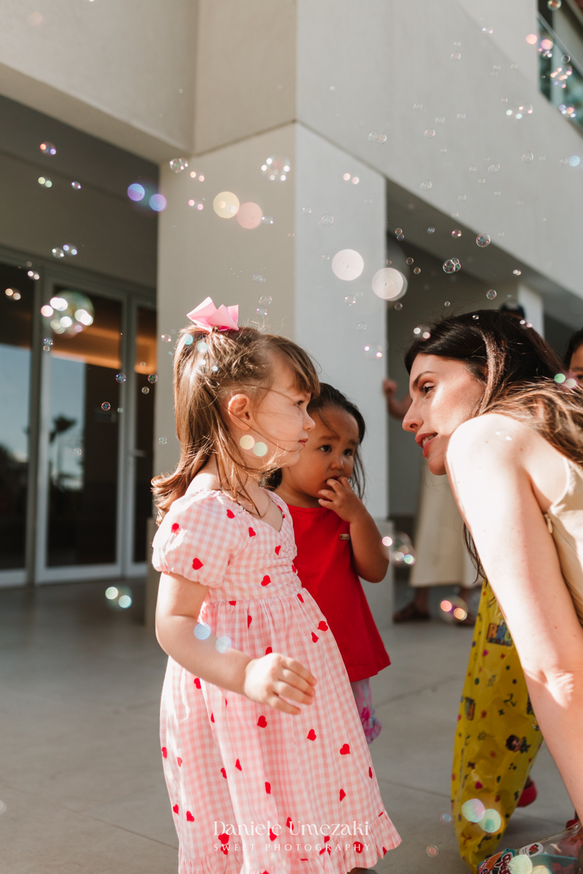 Aurora se divertindo com bolinhas de sabão durante seu aniversário de 2 anos. Fotografia de aniversário infantil em Mogi das Cruzes, com registros espontâneos e afetivos por Dani Umezaki