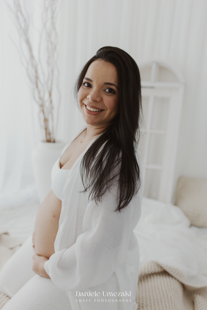 Ensaio gestante em estúdio em Mogi das Cruzes de Cíntia e Rui, registrando a espera pelo bebê com fotografias leves, naturais e atemporais realizadas por Dani Umezaki.