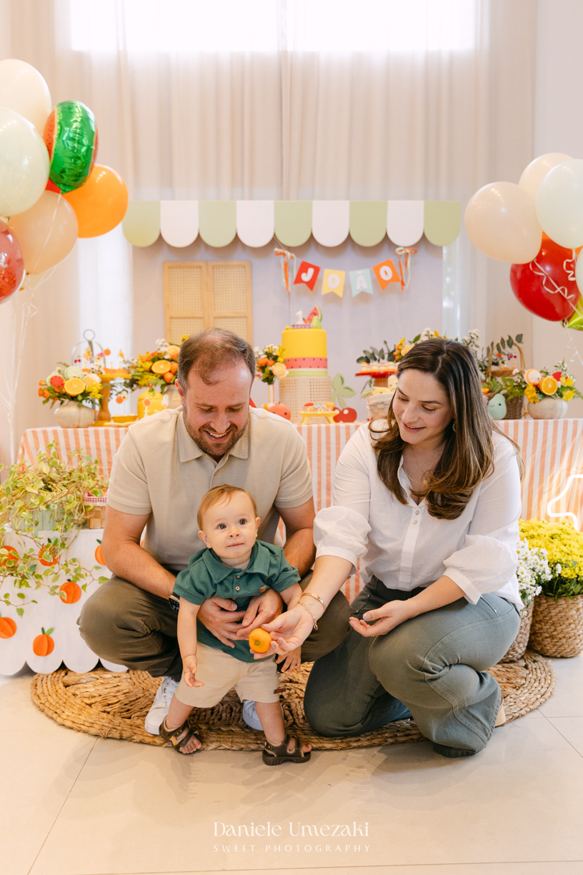 João comemorando seu aniversário de 1 ano com tema de frutas em festa realizada no salão do condomínio, com decoração da Cerejeira Decora e fotografia de Dani Umezaki.
