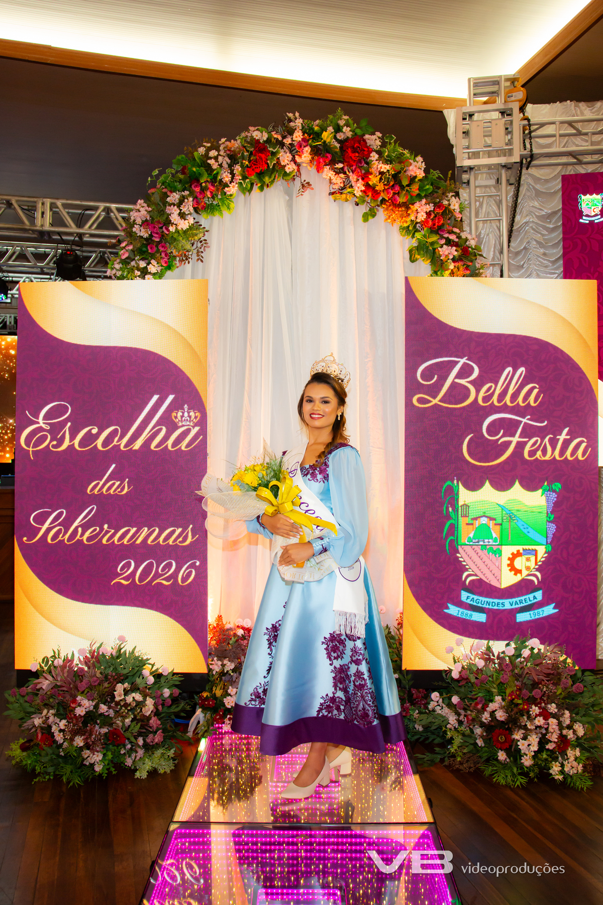 VB Vídeo Produções na Escolha das Soberanas da Bella Festa 2026 em Fagundes Varela. VB Vídeo com estrutura de Foto e Vídeo, Transmissão ao vivo, Painéis de LED Personalizados, Iluminação cênica, Fundo fotográfico.