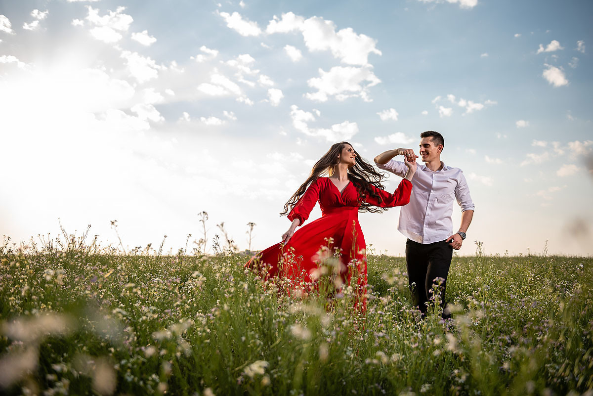 Casal dança sobre campo florido