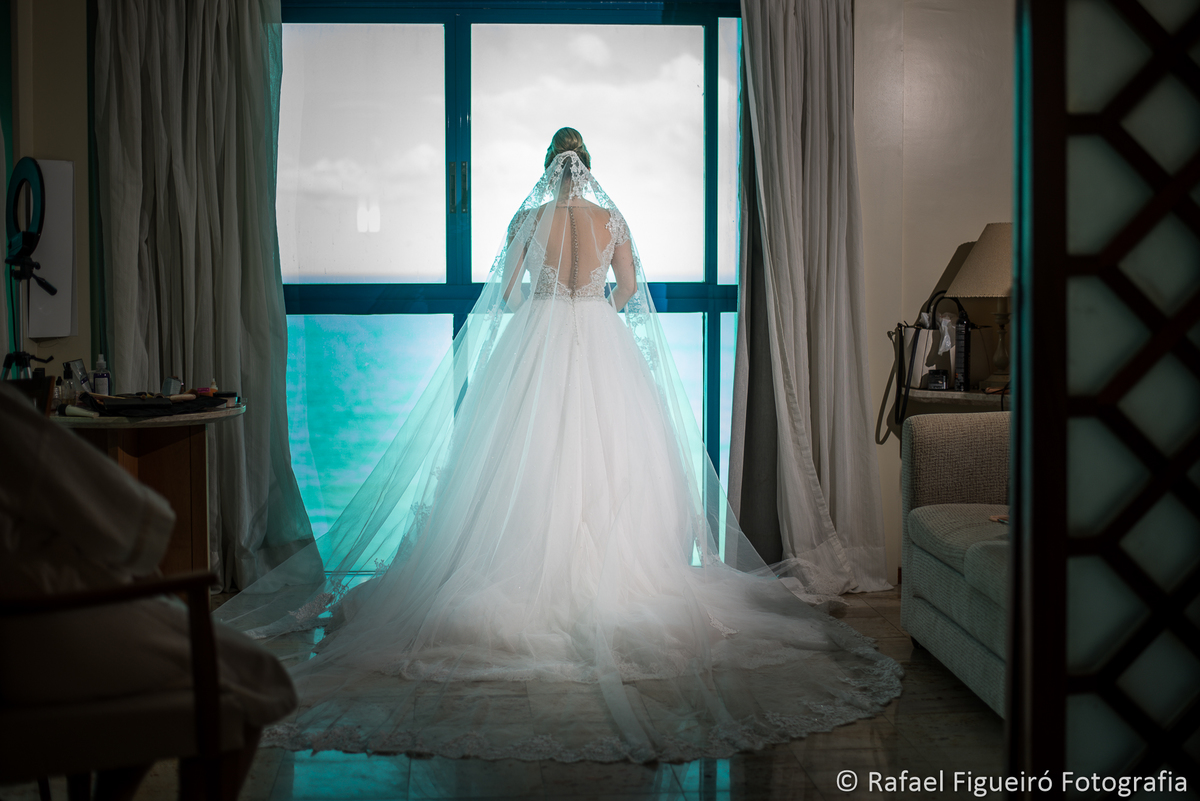 noiva pronta de costas em frente a janela luz linda mar