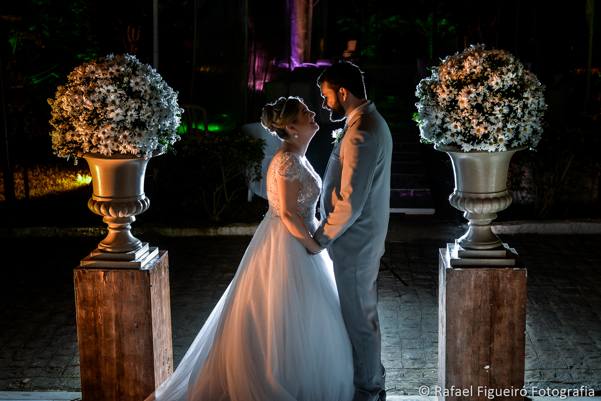 foto perfil casal contra luz entre arranjos flores