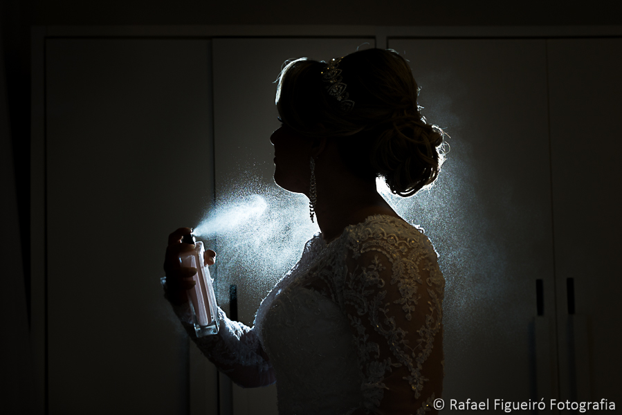 noiva com spray de perfume em contra luz lindo fotografado por Rafael Figueiró fotógrafo melhor de casamentos em Recife-PE
