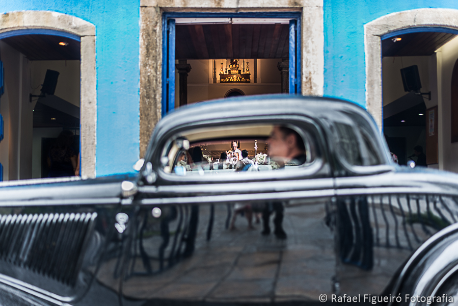 Vista em perspectiva através da janela do carro antigo dos noivos no altar dentro da igreja fotografado por Rafael Figueiró melhor fotógrafo de casamentos de Recife-PE