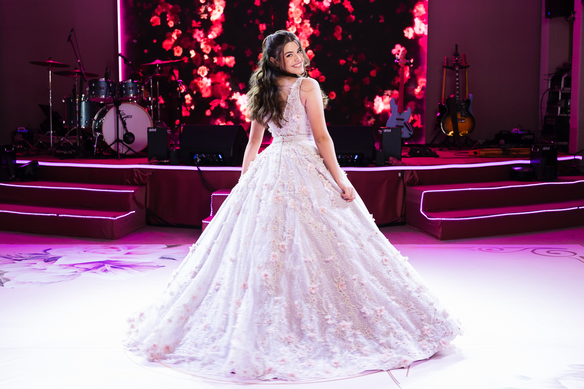Foto da Debutante Laura em frente a pista de dança e palco da festa dos quinze anos da Laura Macedo.
