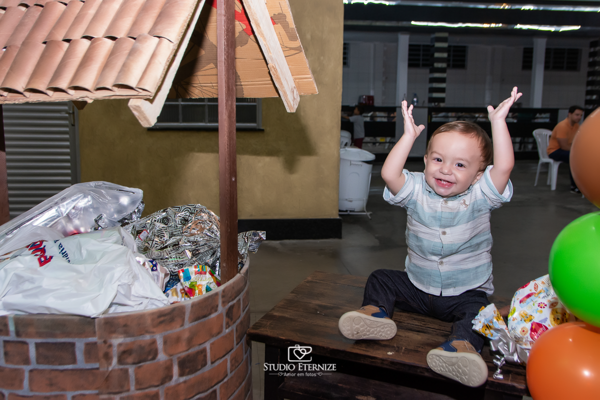 Fotografia de aniversario infantil no tema fazendinha realizado em Poços de Caldas. Aniversariante com seus presentes.