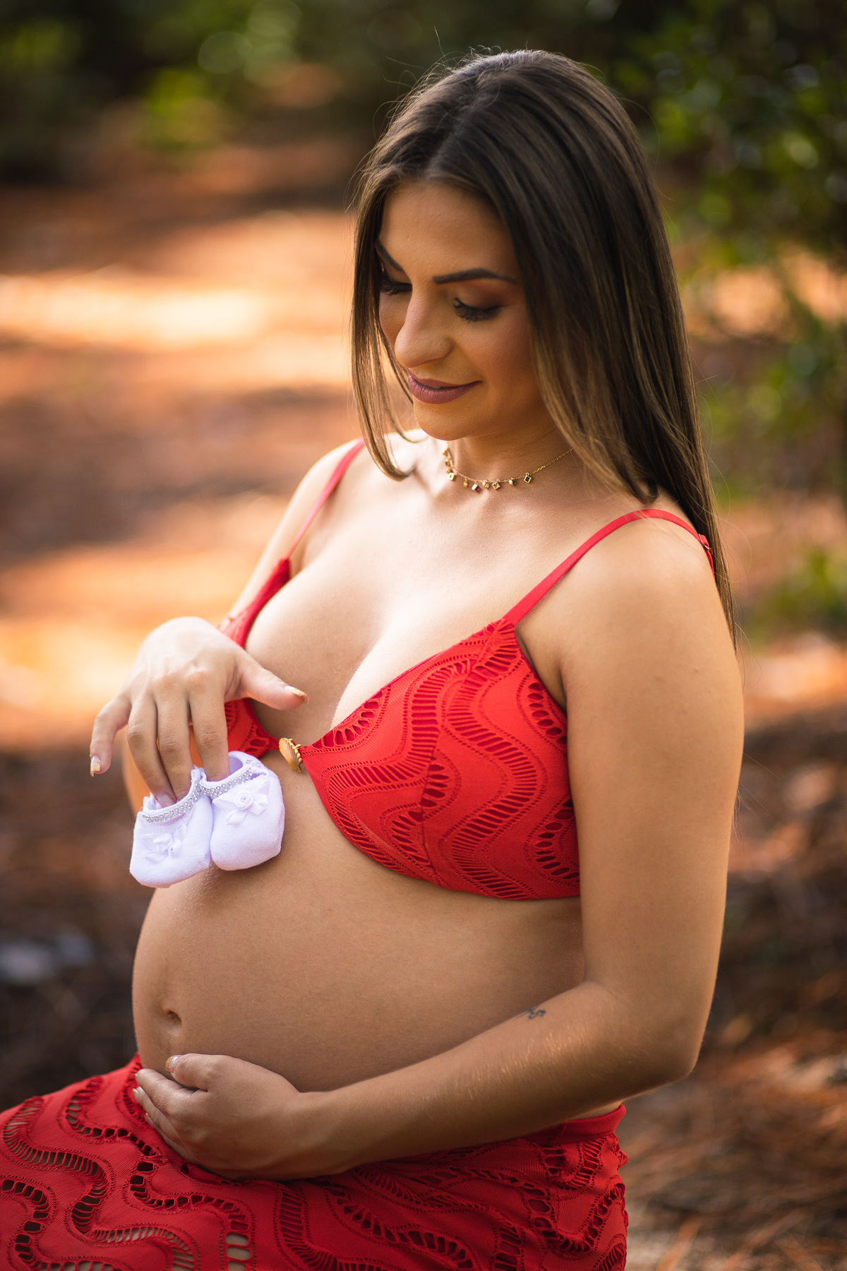 Uma foto que transborda amor! Nessa imagem, a mamãe Paula exibe com orgulho e felicidade a barriga que carrega a preciosidade que está por vir. O cenário naturalmente belo emoldura a imagem, criando uma atmosfera serena e encantadora. 