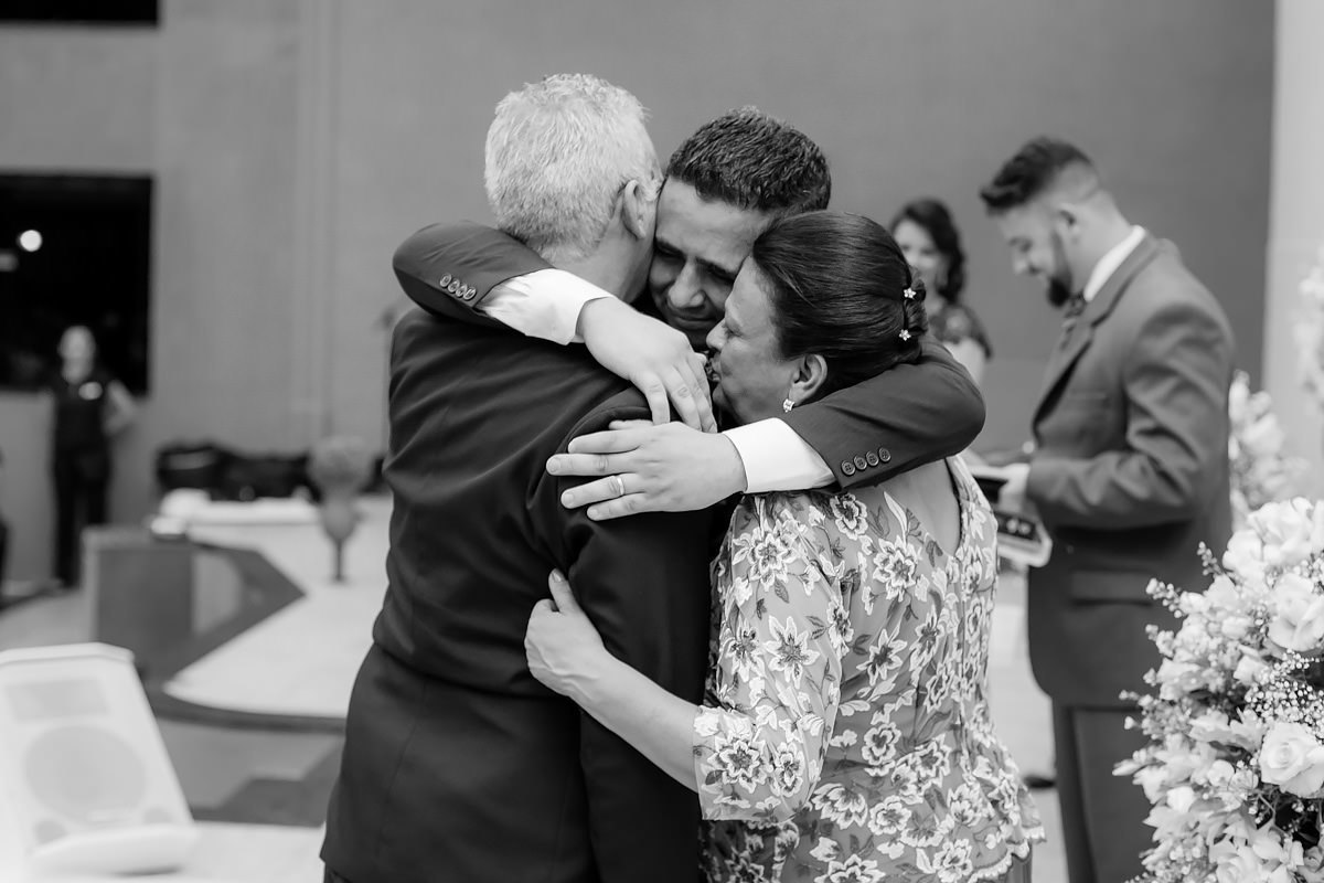 noivo emocionado abraçando os pais no altar no dia do casamento click do fotógrafo de casamentos em BH João Paulo