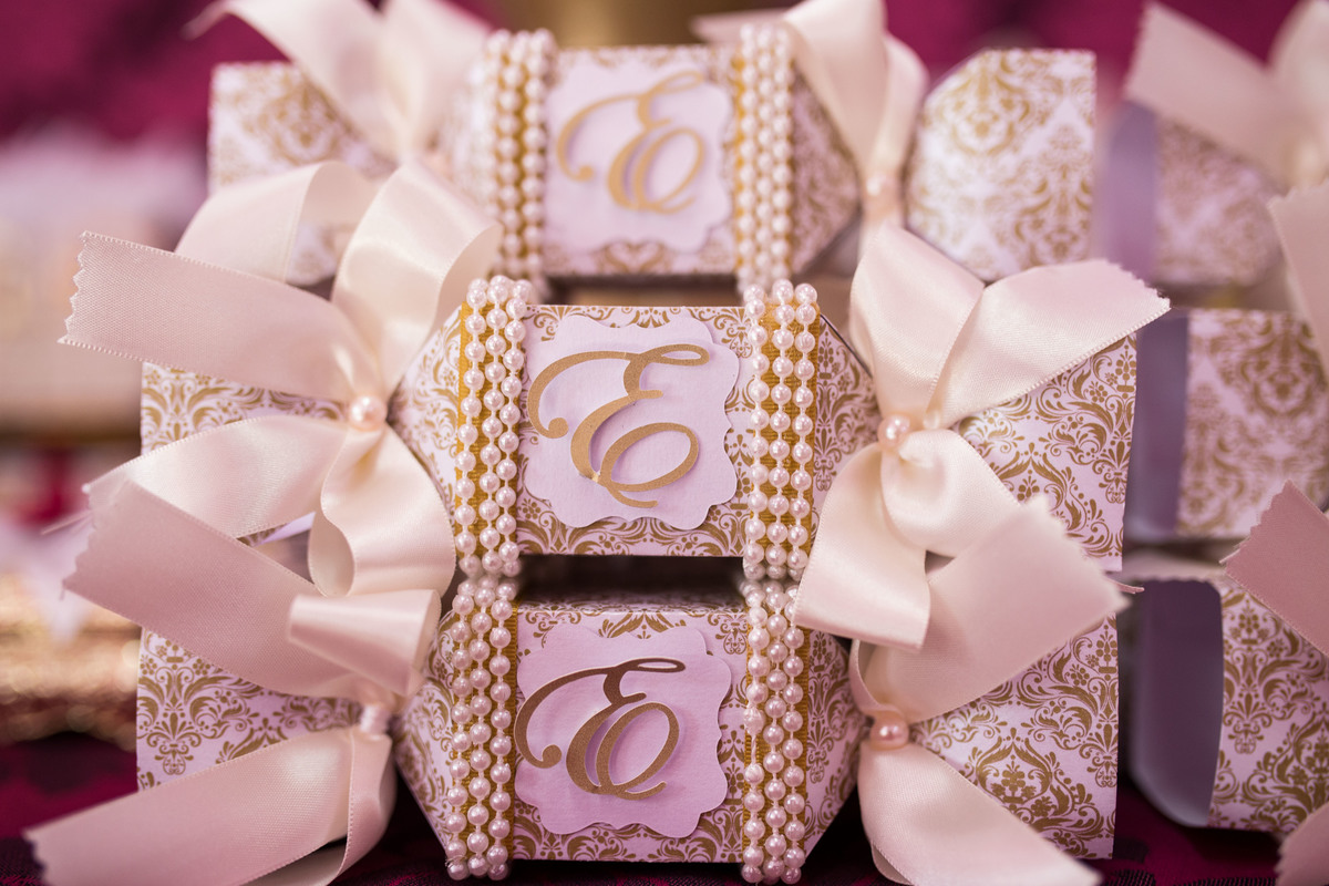 doces enfeitando a mesa principal, coroas e laços dão um charme a esses deliciosos docinhos