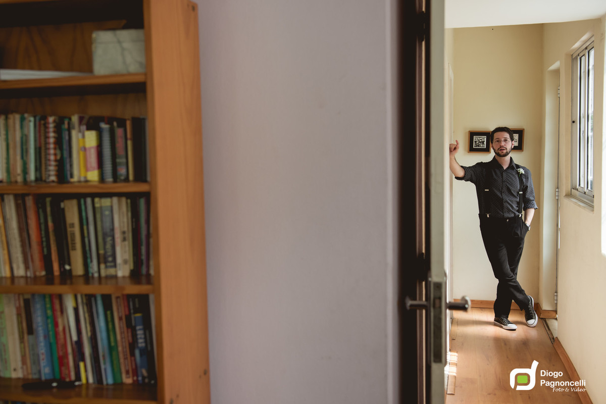 Biblioteca com noivo ao fundo no corredor. Foto Diogo Pagnoncelli.