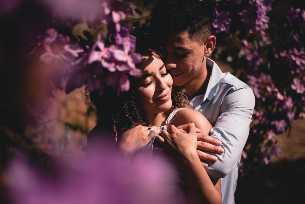 Ensaio Pré Casamento em Nova Friburgo, foto do casal se abraçando de olhos fechados com flores roxas em volta deles