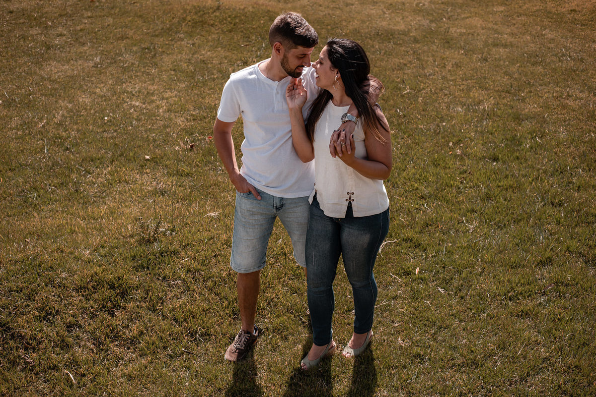 Ensaio externo de casal em Nova Friburgo, foto tirada de cima do casal se olhando e caminhando no gramado
