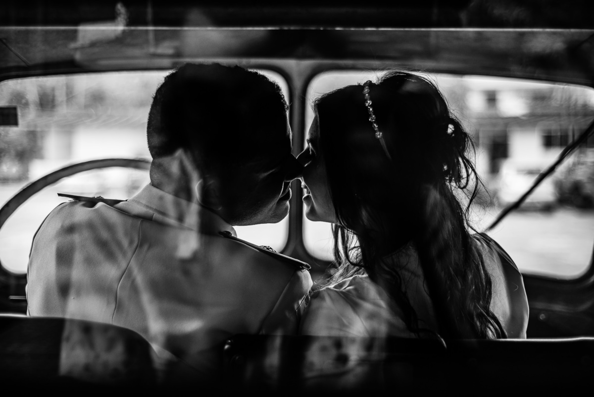Ensaio pós casamento em Nova Friburgo, foto em preto e branco do casal se beijando dentro do carro antigo
