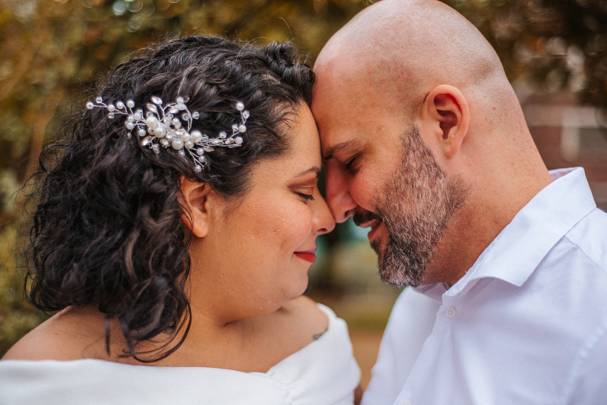 Close de Stefhanie e John com as testas encostadas durante ensaio fotográfico de casal ao ar livre em Farroupilha.