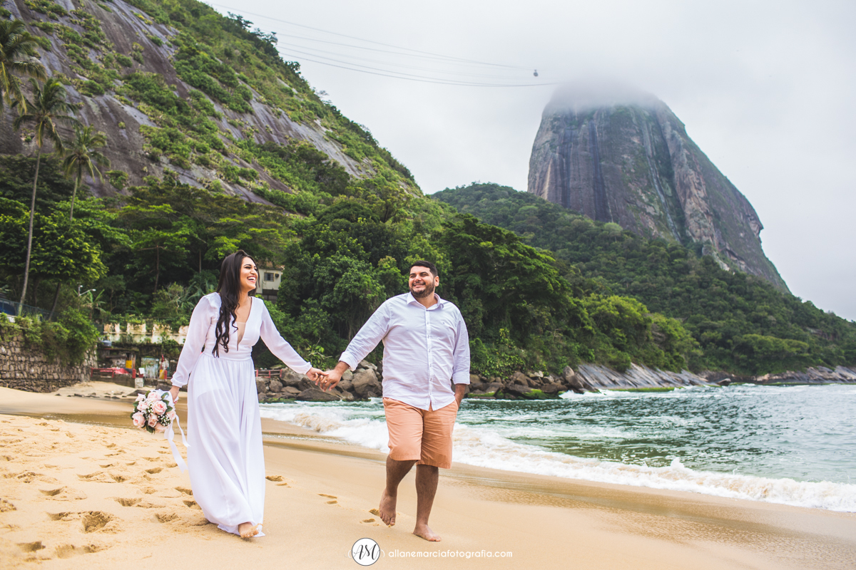 casal caminhando na praia vermelha