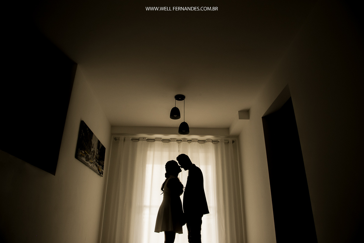 fotografia de casal silhueta na janela do apartamento