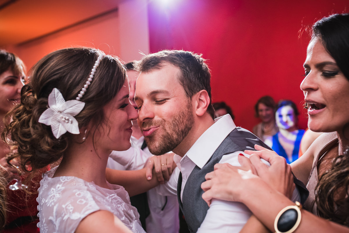 O noivo Pedro tentando beijar a noiva Karine na festa de casamento na Galeria Scenarium/Rio Scenarium, Rio de Janeiro/RJ