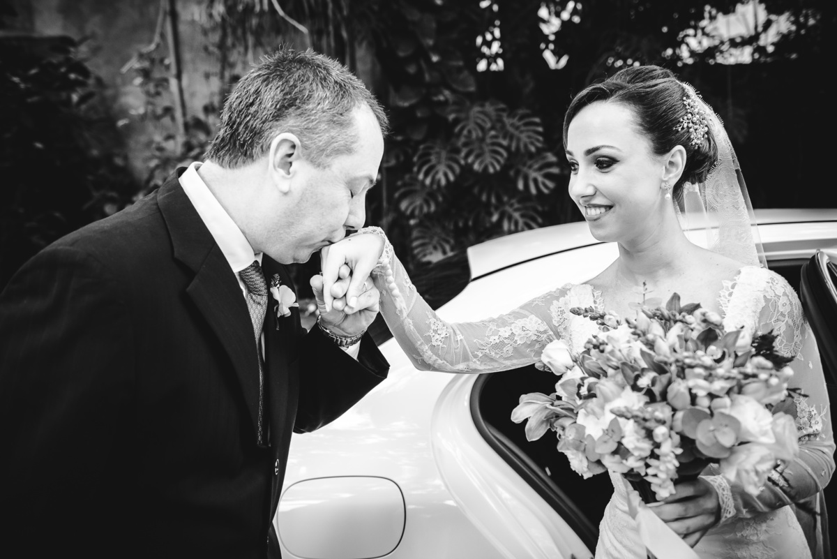 Pai da noiva Luana tirando sua filha do carro e beijando sua mão, antes da entrada na igreja para a cerimônia do casamento, Capela Santa Ignez, Gávea, Rio de Janeiro-RJ
