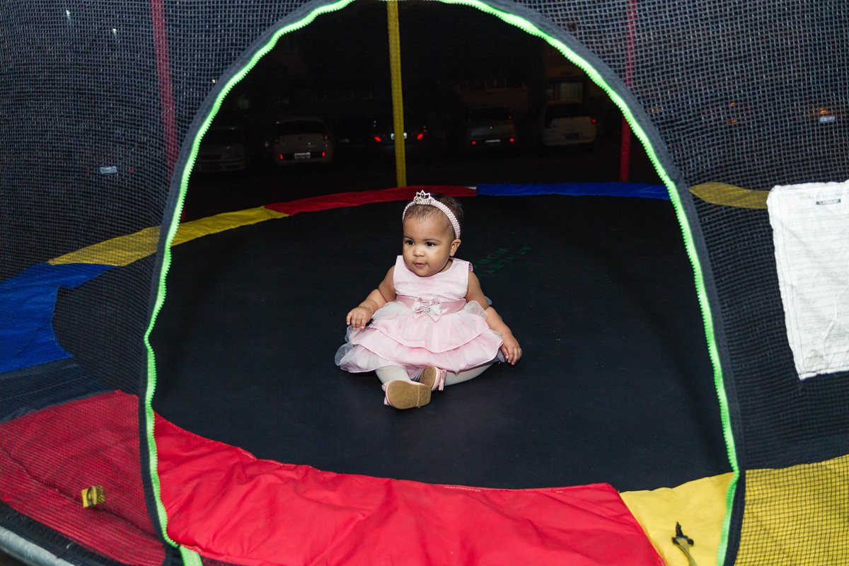 Luísa sentada no pula pula pelo fotógrafo Douglas Maia