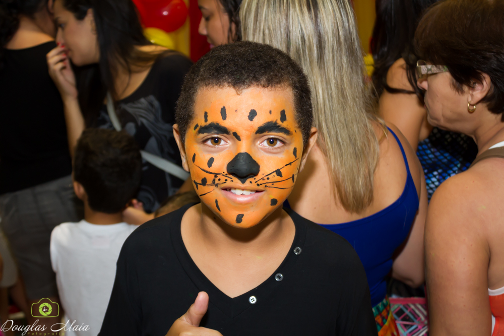 Menino feliz feliz com rosto pintado pelo fotógrafo Douglas Maia