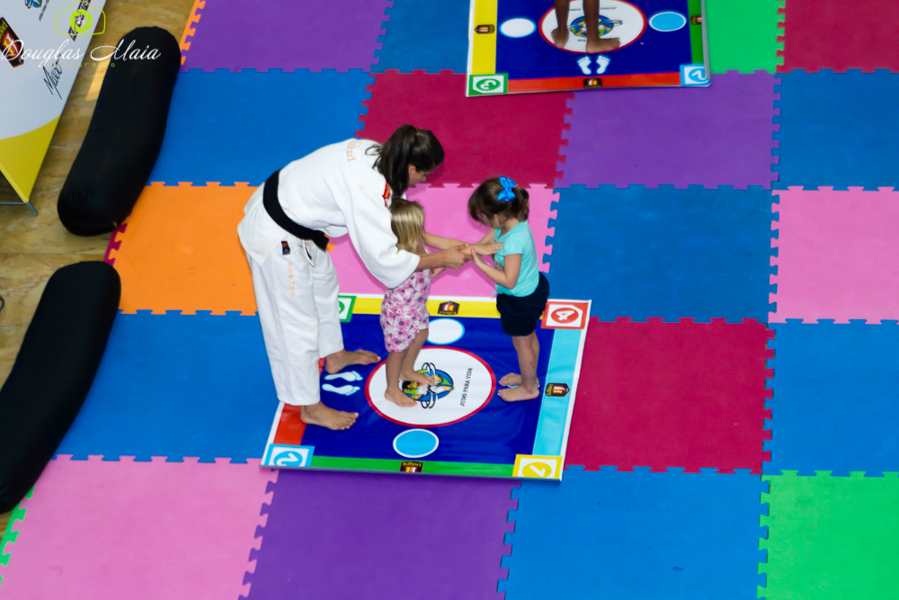 Atleta ensinando judô para meninas pelo fotógrafo Douglas Maia